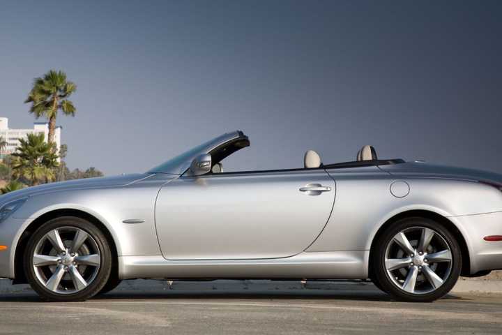 Static side profile shot of a silver 2010 Lexus SC 430 parked on a beach.