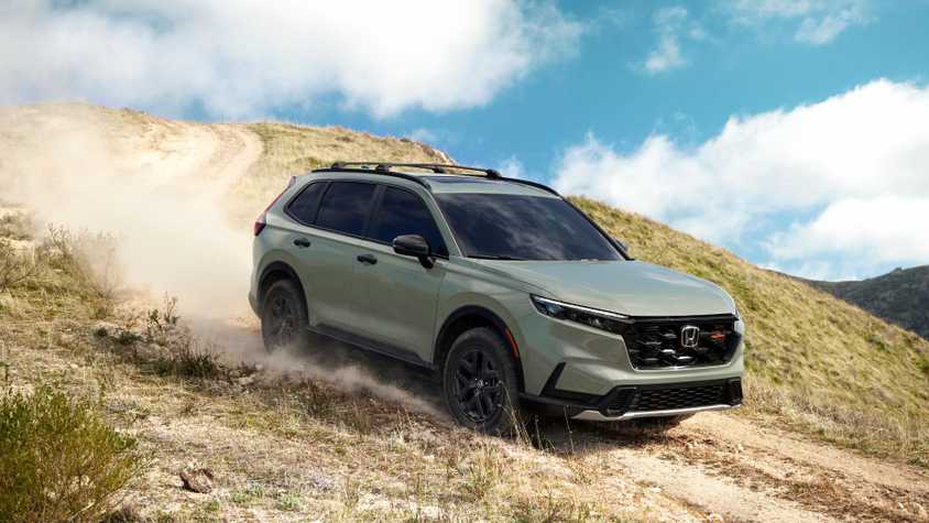 Dynamic front 3/4 shot of a green 2026 Honda CR-V TrailSport off-roading.