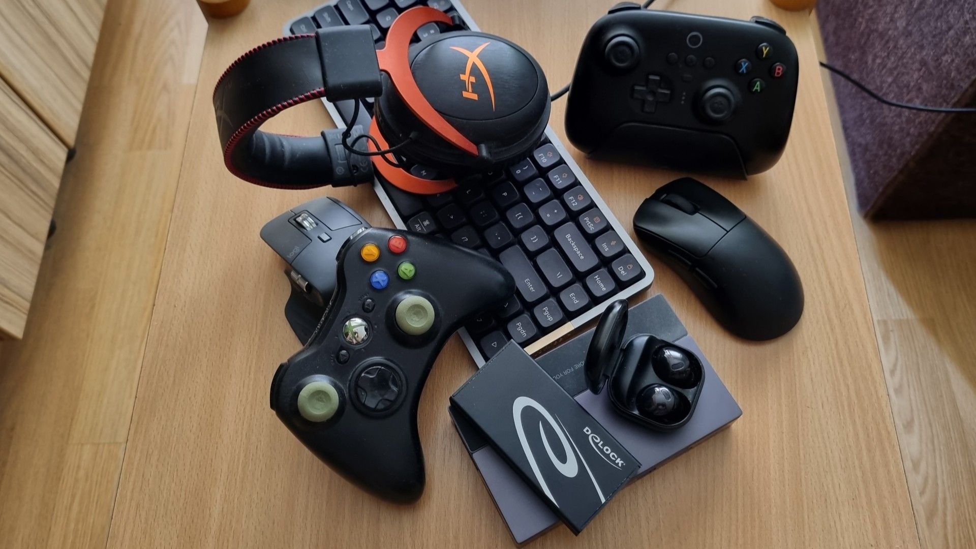 A bunch of gadgets lying on a table. 