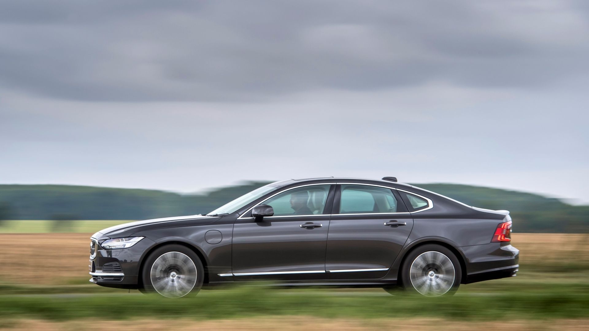 Side profile action shot of a 2025 Volvo S90 