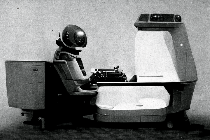 A round robot typing on a typewriter