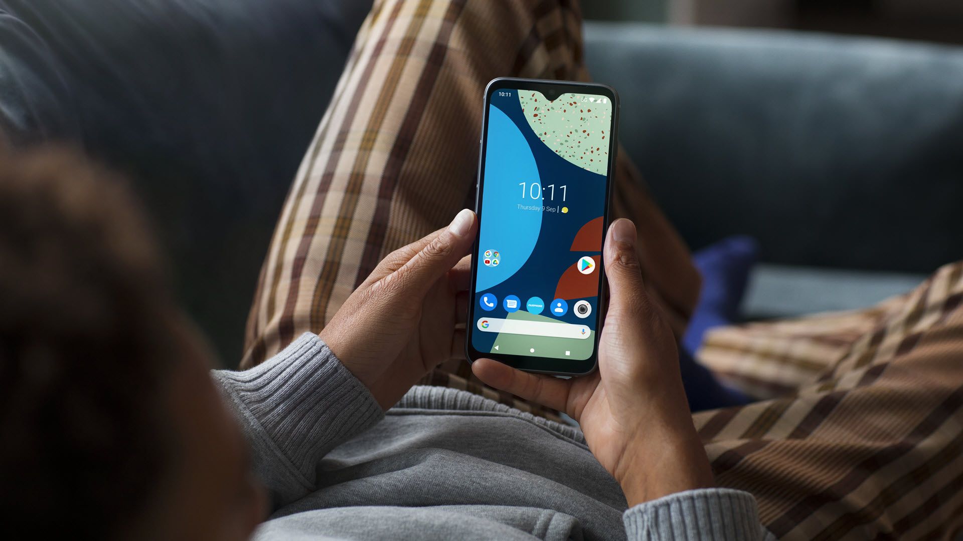 Fairphone 4 in a person's hands.