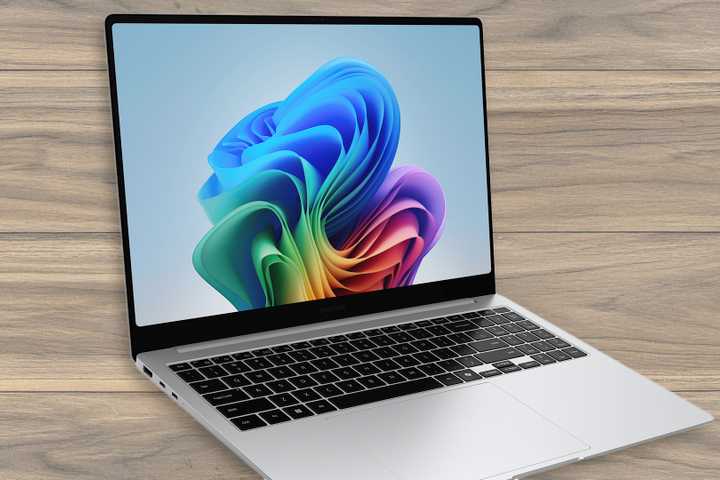 The Samsung Galaxy Book 5 Pro over a wooden textured background.