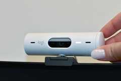 A webcam attached to the top of a screen. 