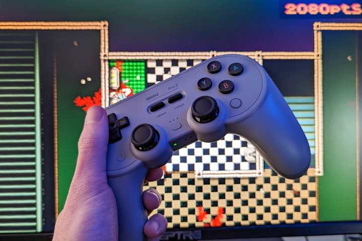 8Bitdo Pro 2 wireless controller with a computer monitor
