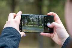 Samsung phone taking a photo with camera open.