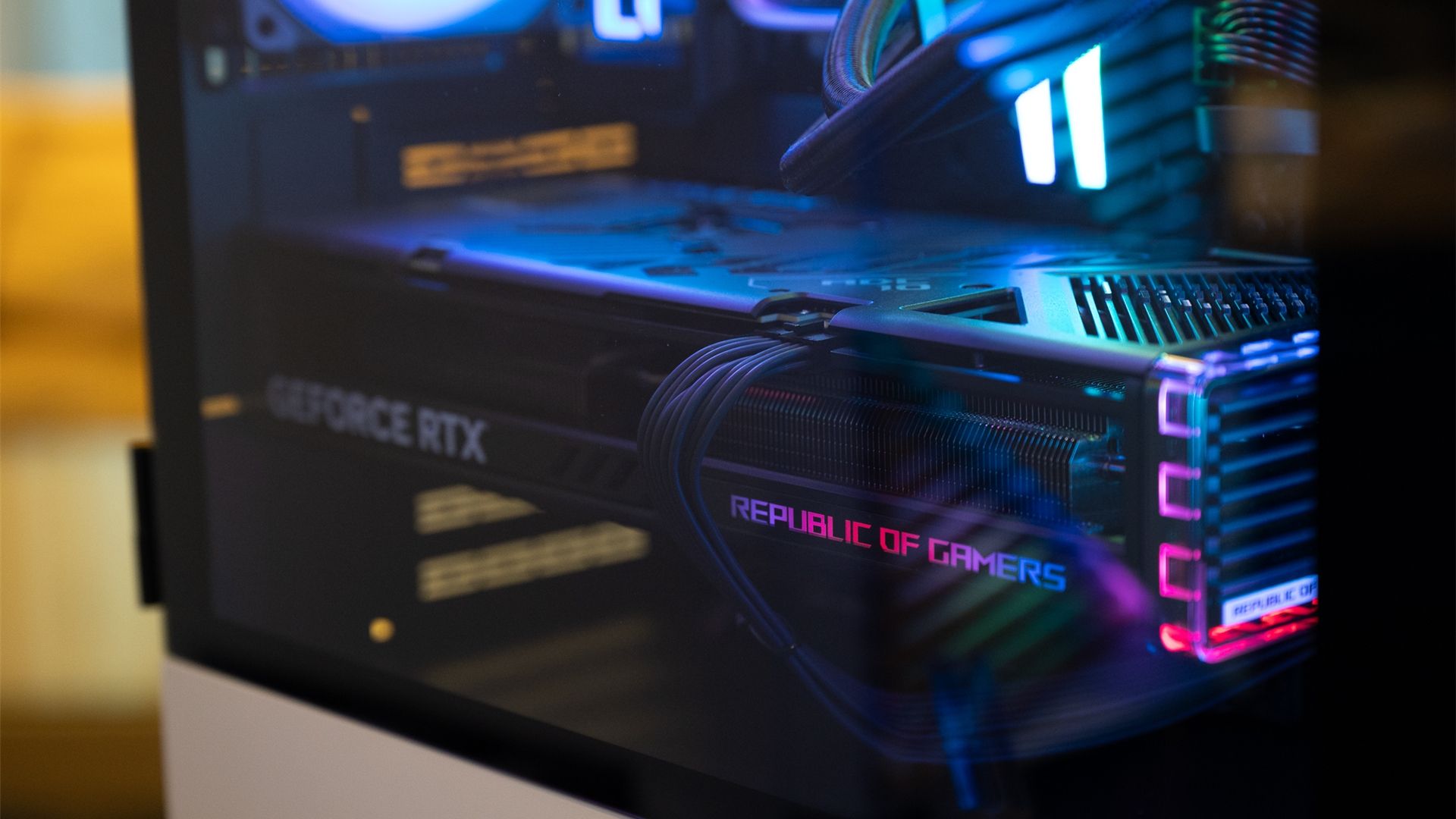 A gaming PC with a large power cable running to a GPU. 