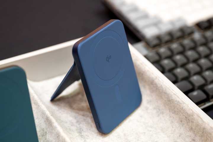 Satechi OntheGo Power Bank in blue propped up on a table.