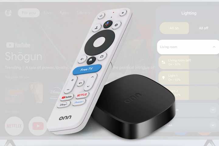 The Onn 4K Plus streaming box and voice remote over a photo of a TV.