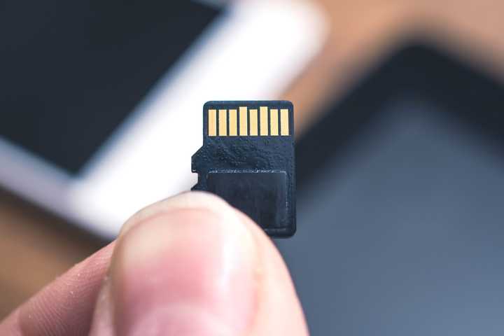 MicroSD card in someone's hand.