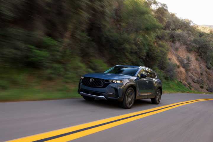 Front 3/4 action shot of a 2025 Mazda CX-50