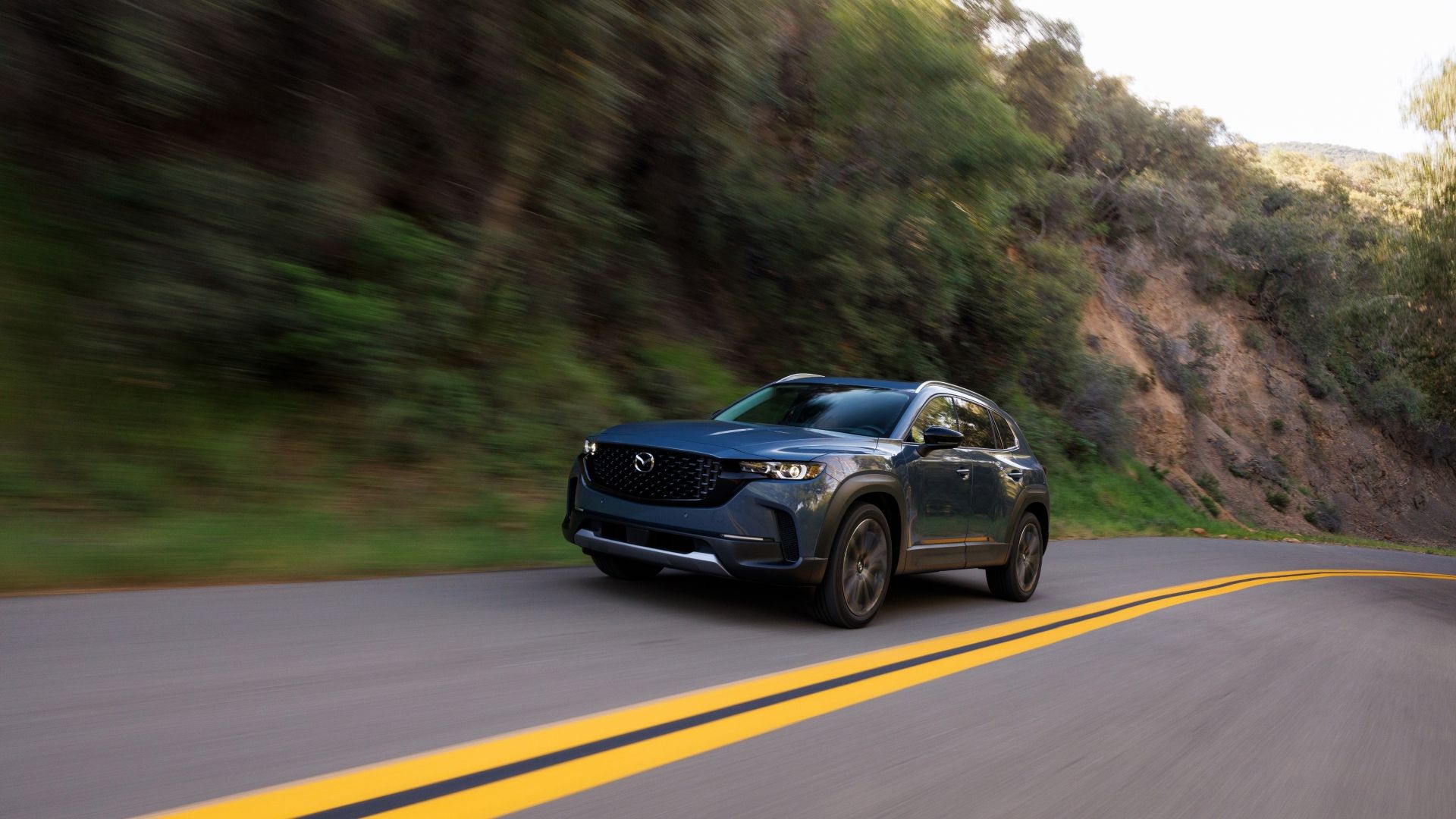 Front 3/4 action shot of a 2025 Mazda CX-50