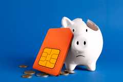 A broken piggy bank with a SIM card leaning against it.