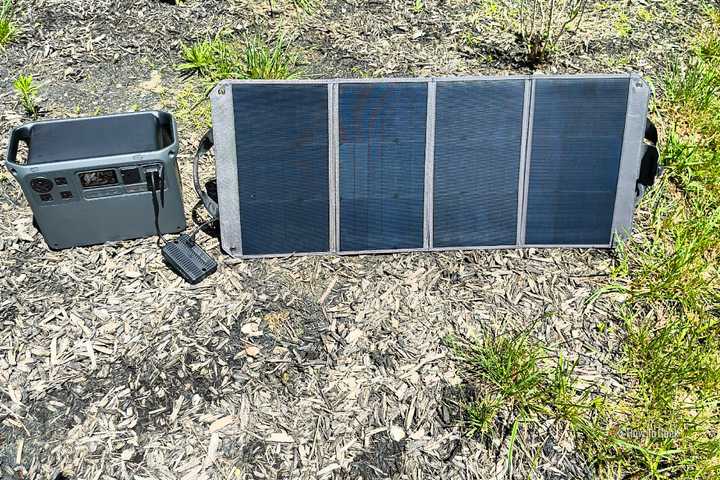A DJI Power 2000 charging via a 100W portable solar panel.