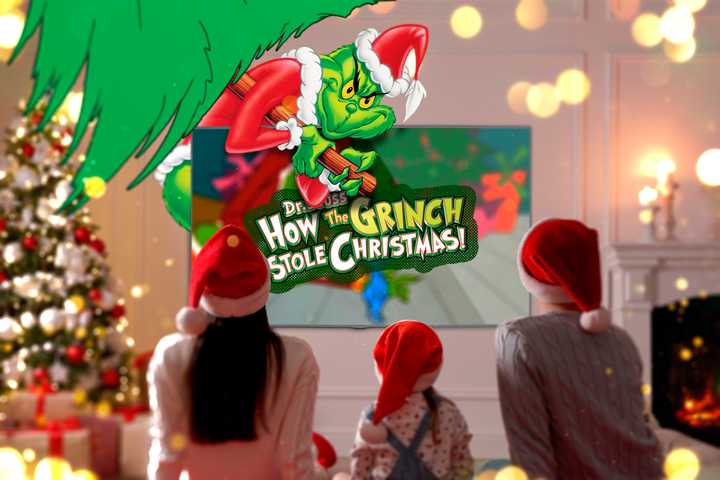 A family watching 'How the Grinch Stole Christmas' in a living room decorated for Christmas.