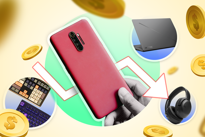 A hand holding a phone, some tech products beside it, and several coins around.