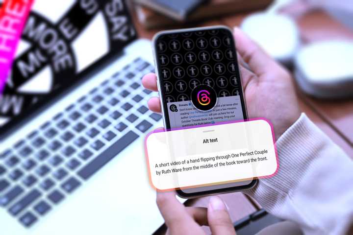 A hand holding a phone with an alt text description of a video on Threads.