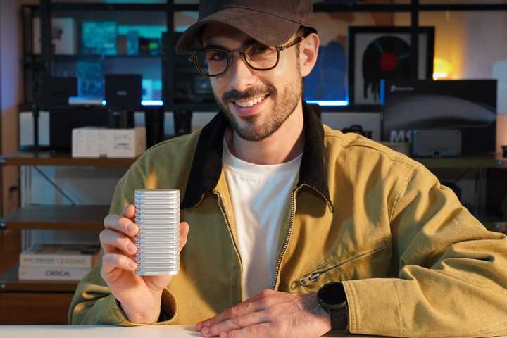 A man holding the D1 SSD in his hand and smiling.