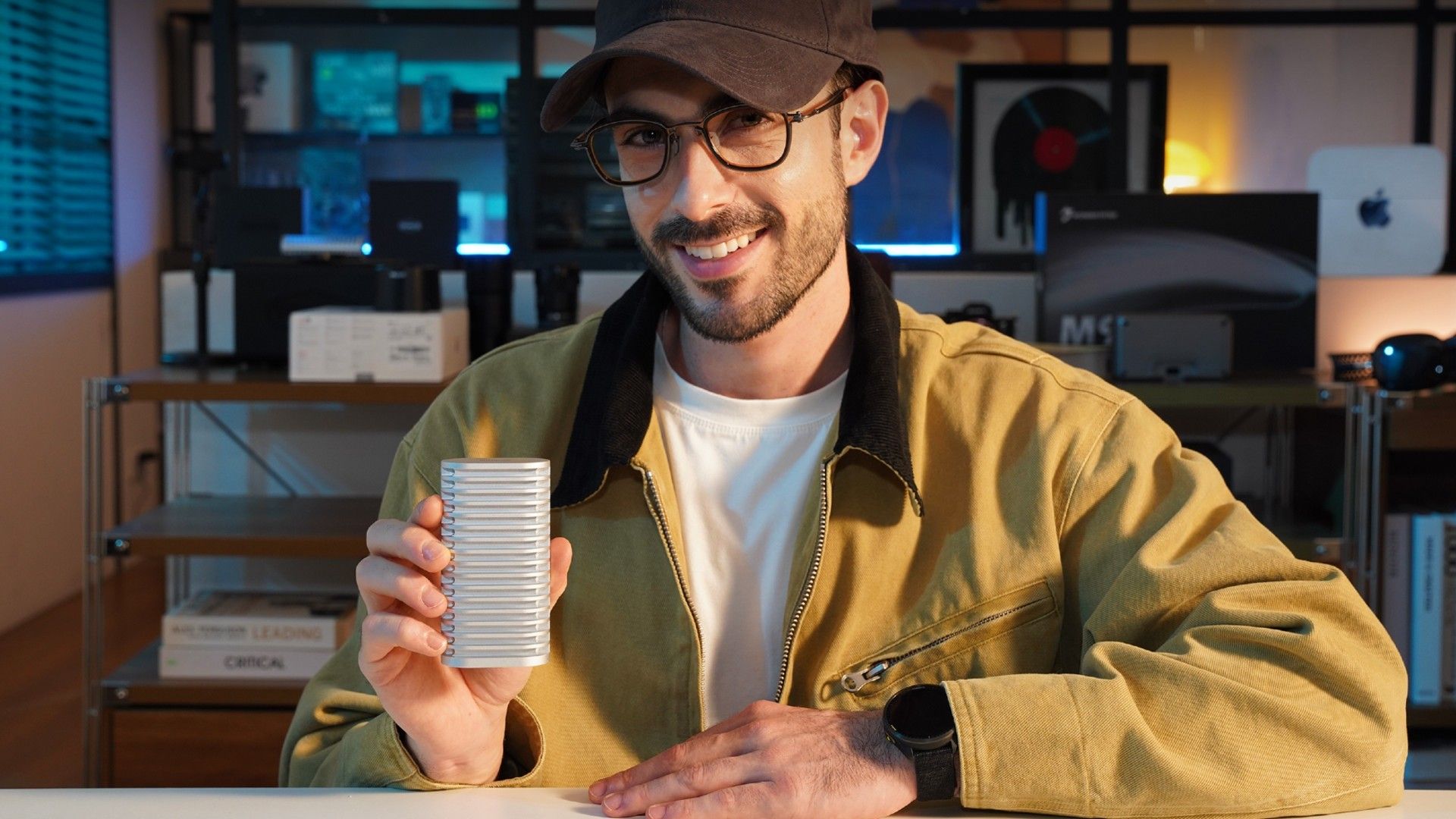 A man holding the D1 SSD in his hand and smiling.