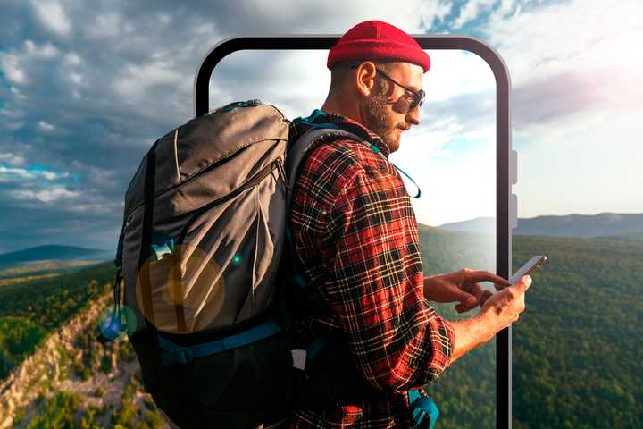 A man on a mountain with a camping backpack.