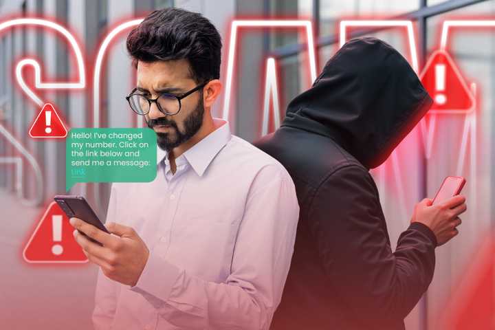 A man receiving a message on his phone with a scammer behind him and warning signs around.