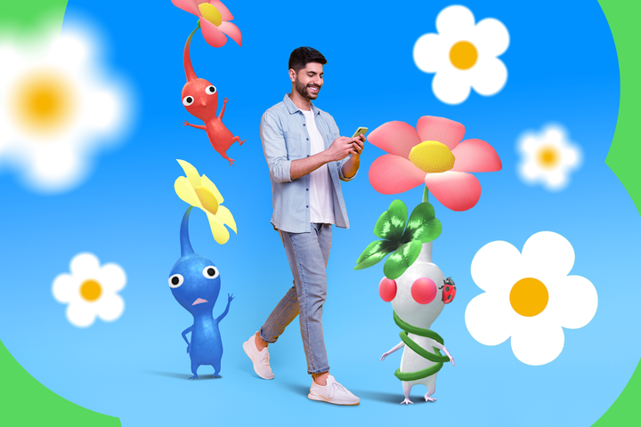 A man walking while using his phone, surrounded by colorful Pikmin Bloom characters and cartoon flowers on a blue background.