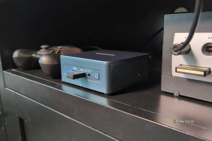 A mini PC with a Steam Controller and a Gamecube in an entertainment center.