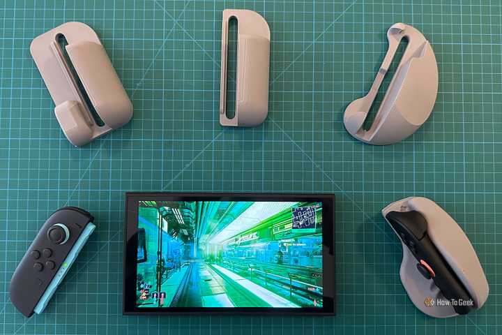 A Nintendo Switch 2 with 3D-printed mouse shells around it.