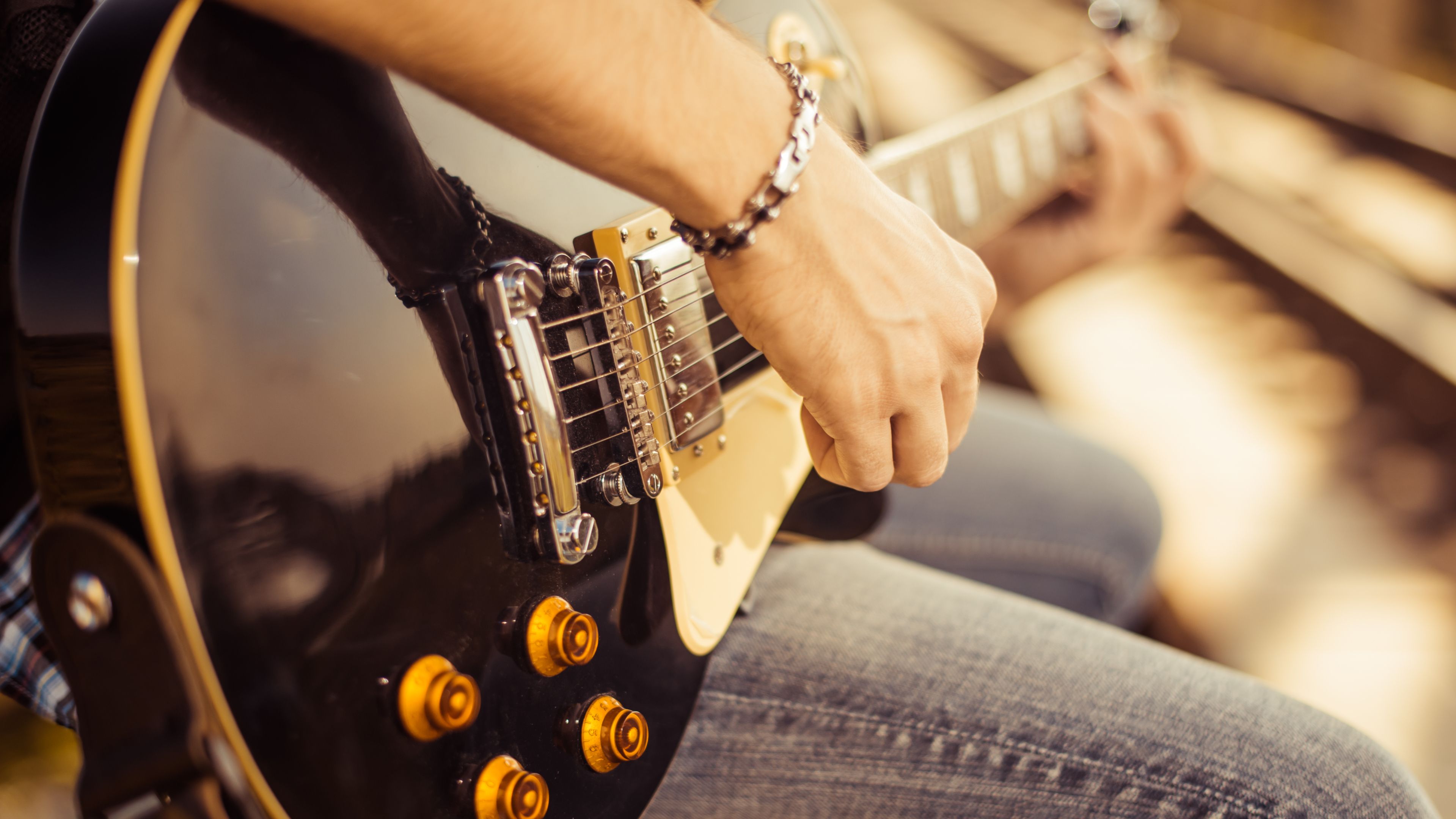A person playing the electric guitar.