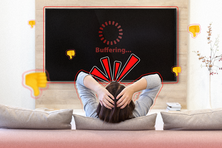A person sitting on a couch, angry, while the TV is buffering.