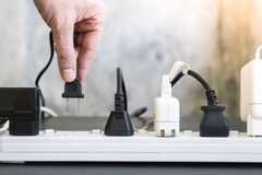 A power board with AC plugs and DC adapters in the sockets.