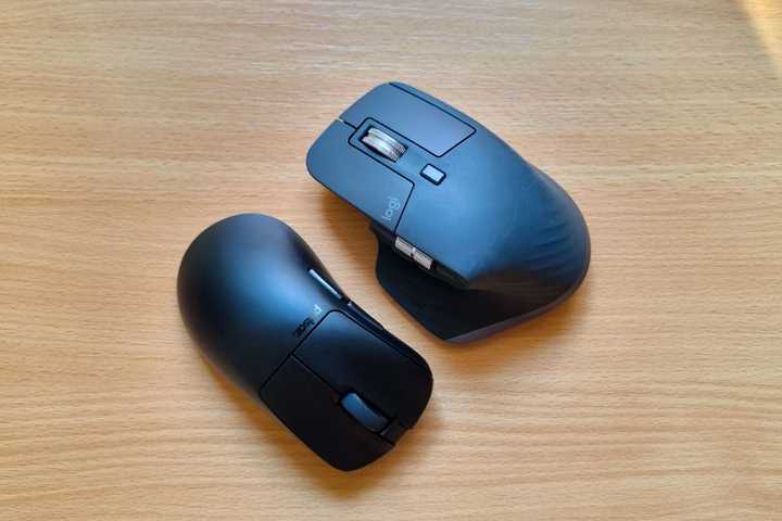 A Pulsar Xlite V3 and a Logitech MX Master 3S lying next to one another.