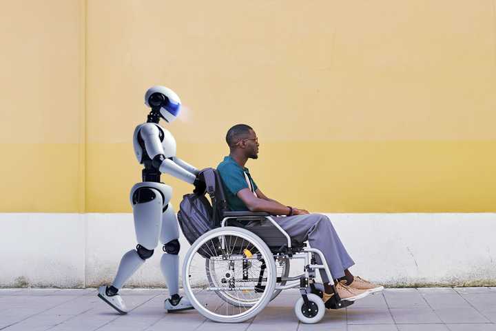 A robot pushing a person in a wheelchair.