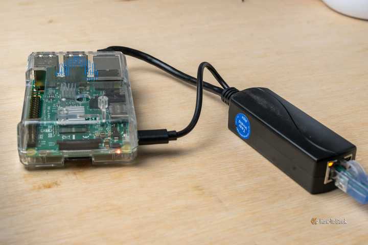 A Power over Ethernet splitter plugged into a Raspberry Pi 3B.