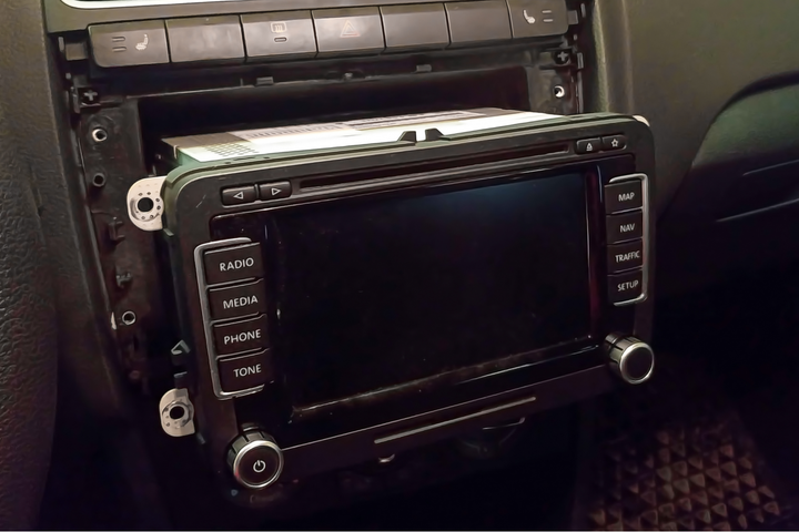 The entertainment unit in a car pulled out for disassembly