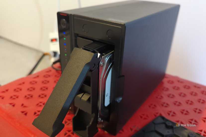 An Asustor NAS with one hard drive pulled partially out of the bay.