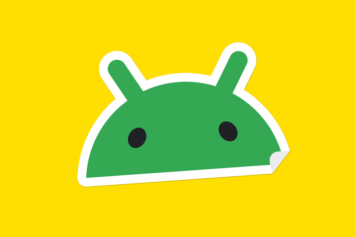 Android robot head sticker on yellow background.
