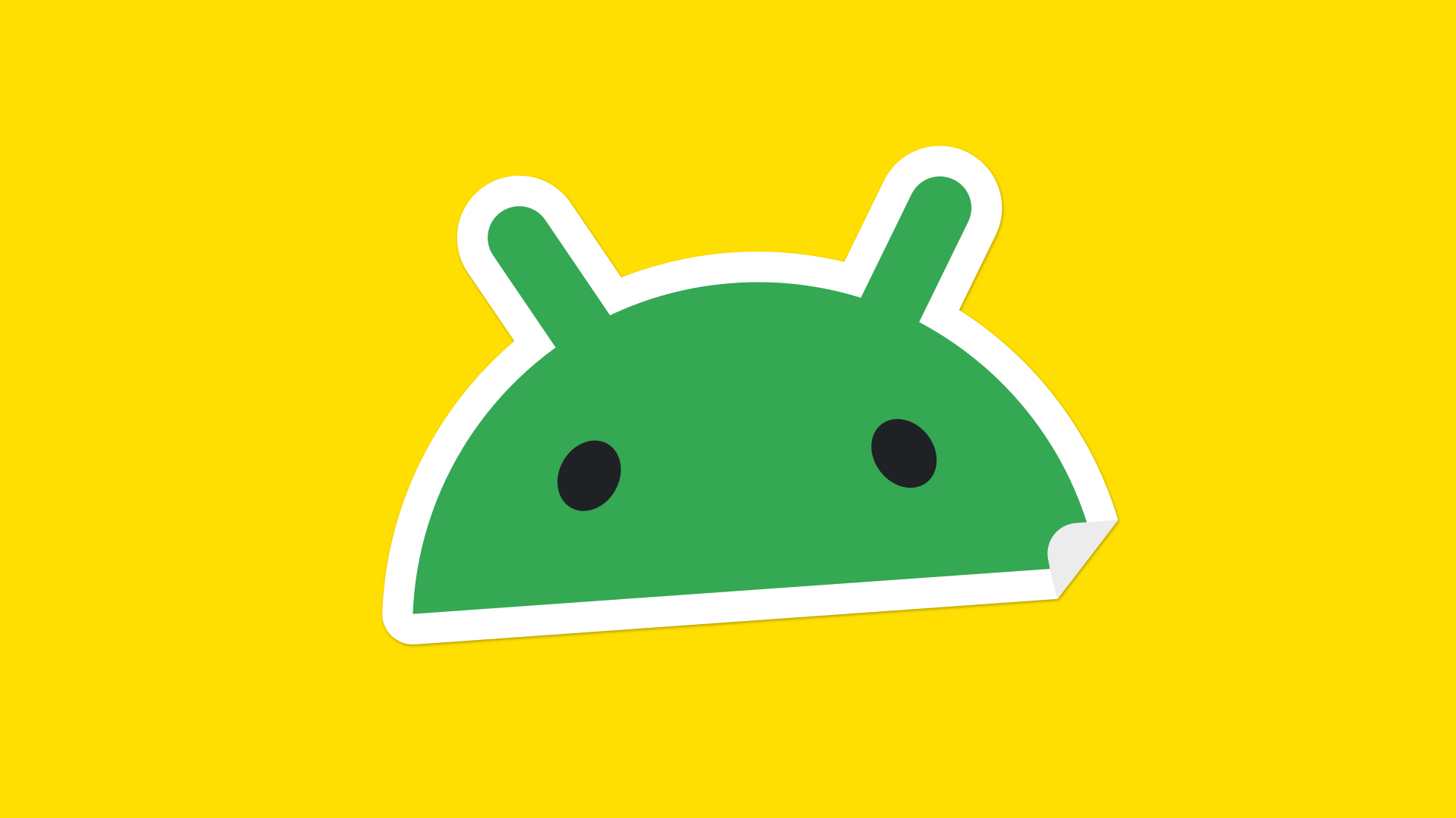 Android robot head sticker on yellow background.