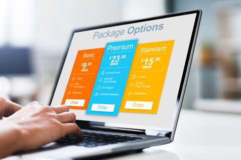Hands typing on a MacBook, the screen has subscription pricing models.