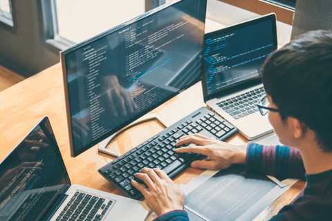 Person coding on multiple devices