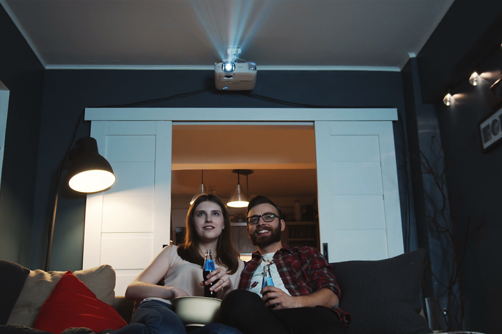 A family with a long-throw projector.