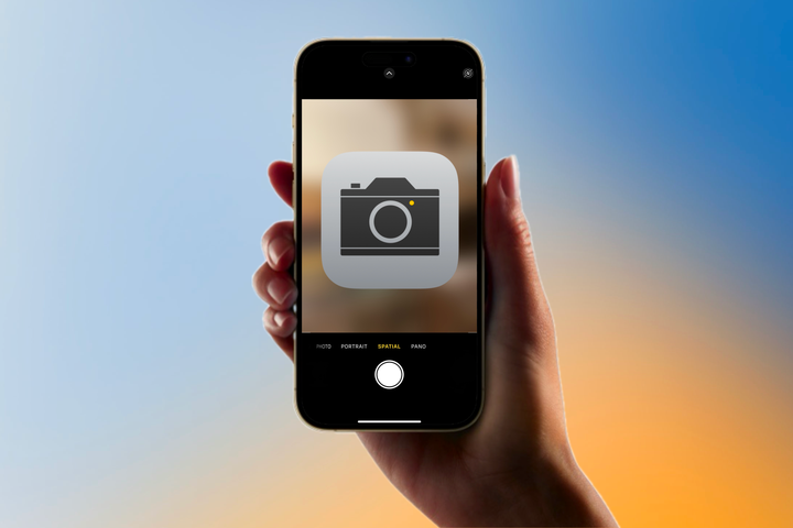 iPhone with camera icon in front of a colorful background.