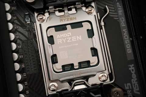 A close-up photo of the AMD Ryzen 7 7700 CPU in the AM5 socket and the ASRock B650M PG RIptide motherboard.