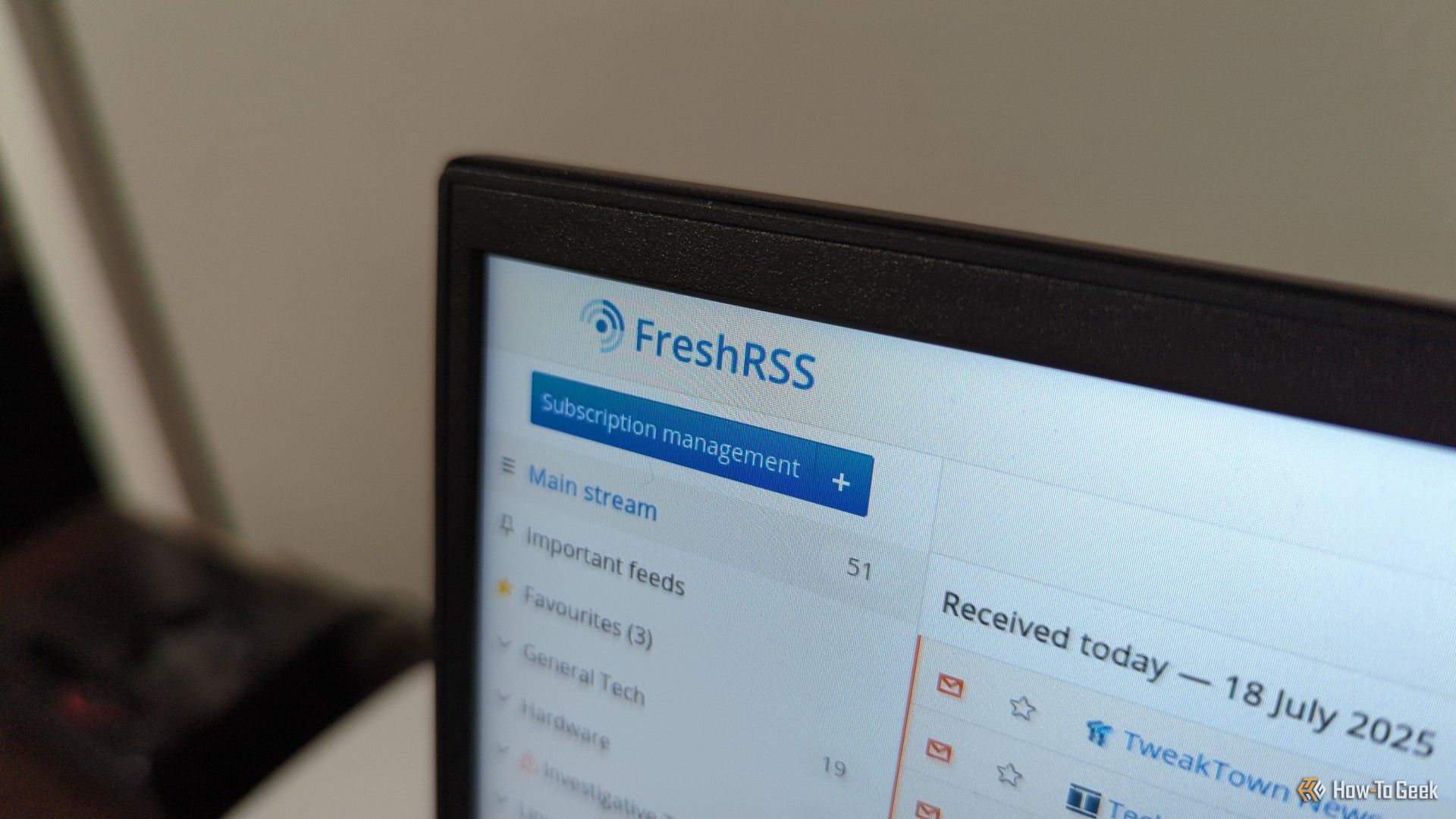 FreshRSS logo on a laptop screen.