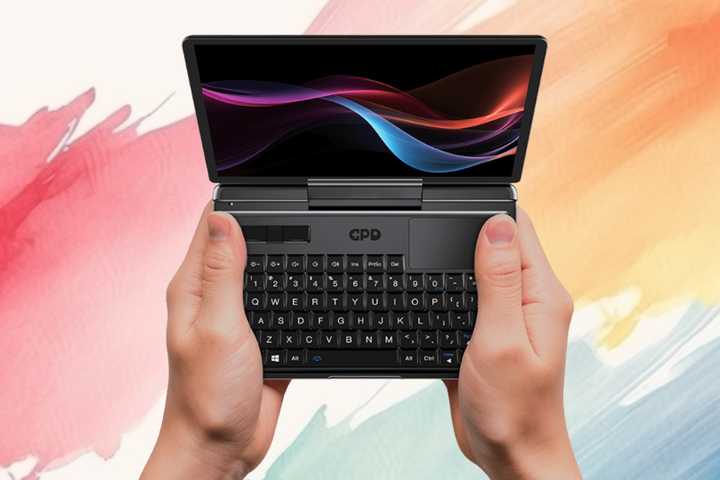 GPD MicroPC 2 in the hands of someone using it on a painted background