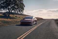 Front view of red Lucid Air Grand Touring driving on a country road.