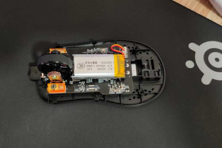 A disassembled gaming mouse.