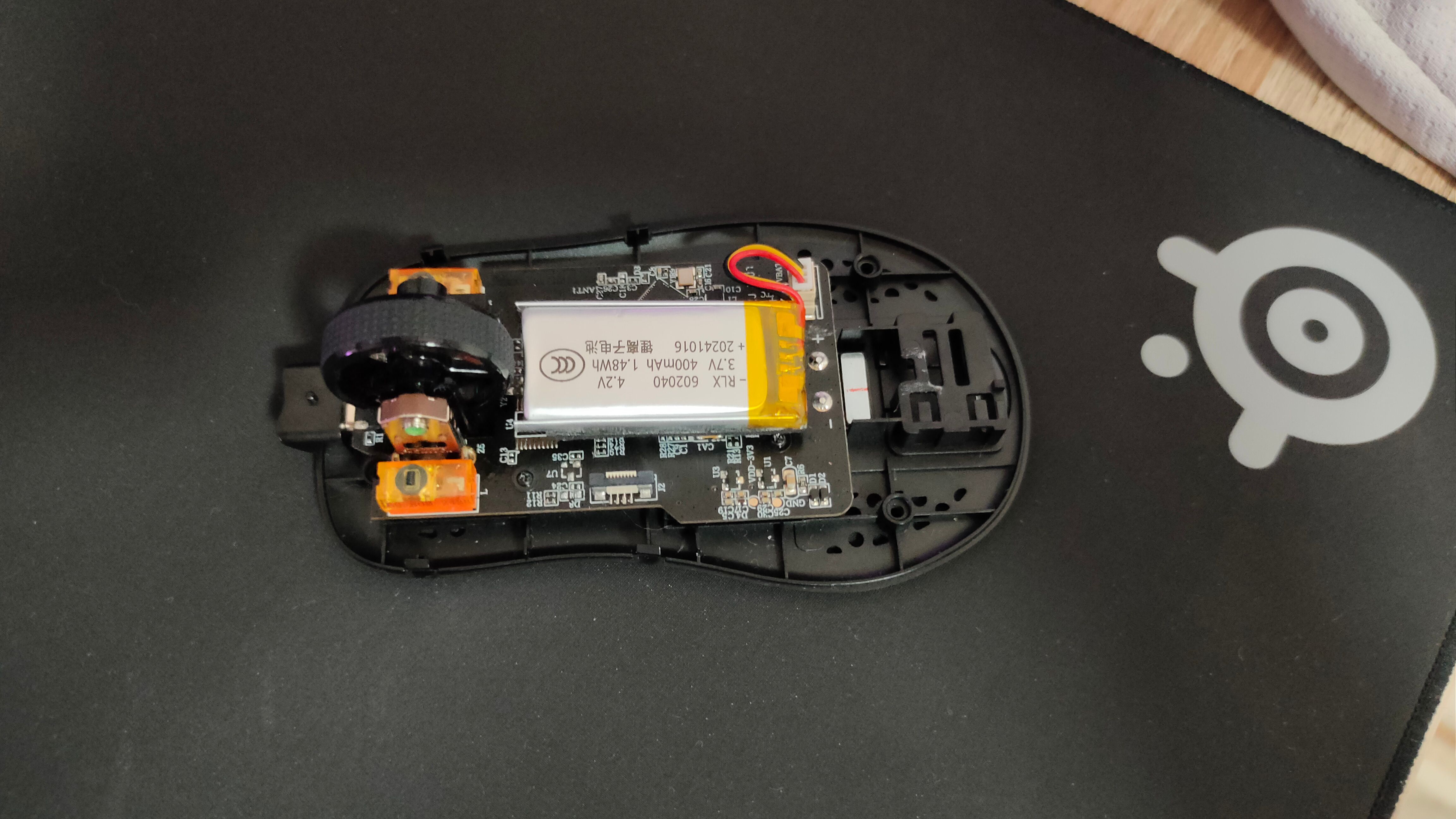 A disassembled gaming mouse.