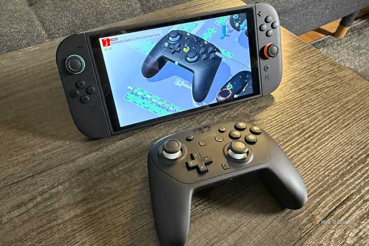 The Nintendo Switch 2 Pro Controller and a model of the pro controller in Nintendo Switch 2 Welcome Tour.