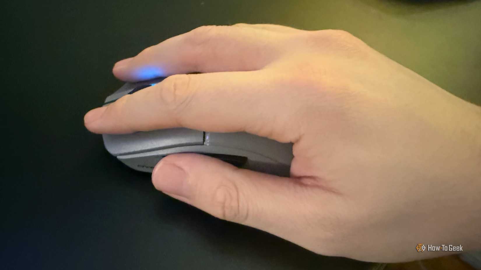 A hand on the HyperX Pulsefire Saga 2 Pro.